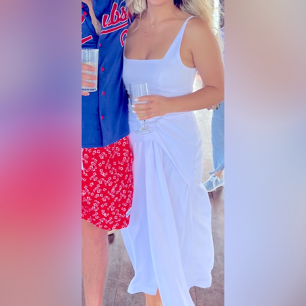 White two piece outfit with front tie skirt and zip up top